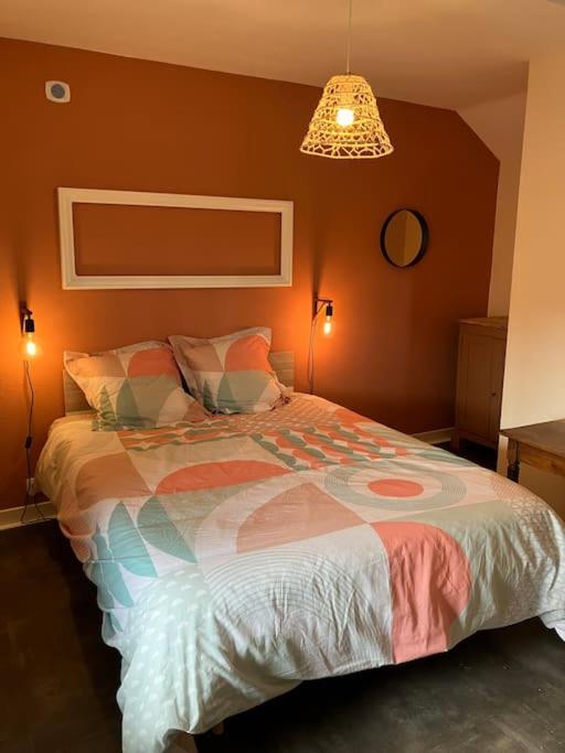 a bedroom with a bed with a colorful comforter at *•*•Nouveau*•*• Chez Mirabelle in Belleville-sur-Meuse