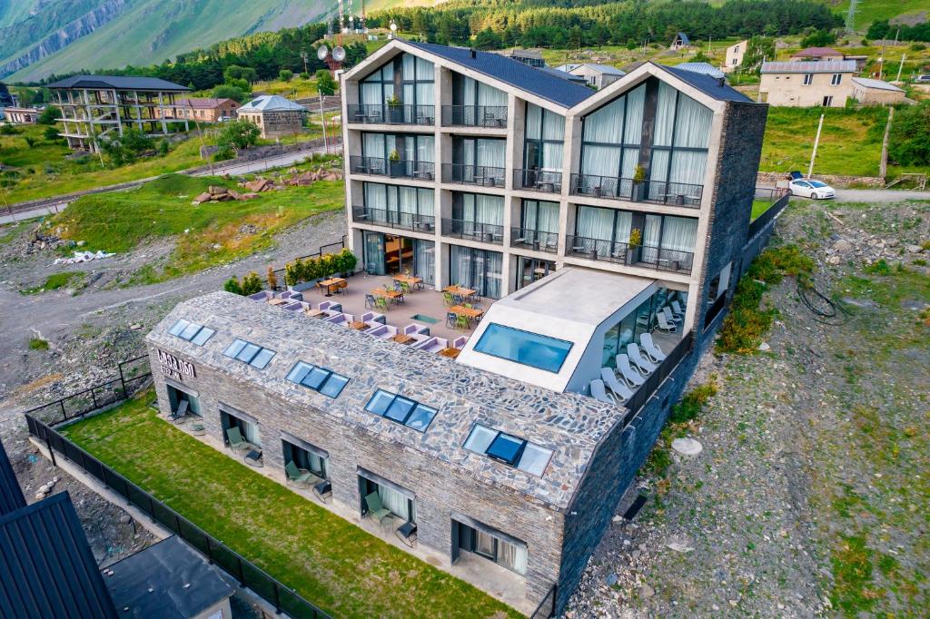 an aerial view of a large building with a balcony at Step Inn - Kazbegi in Stepantsminda