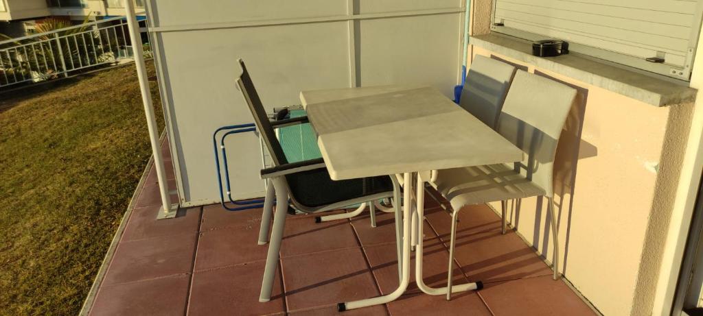 a table and two chairs sitting on a porch at Bellevue- Bellavista in Castagnola