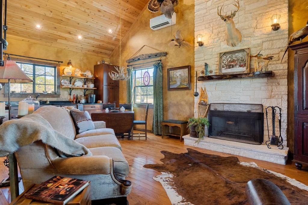 a living room with a couch and a fireplace at Inn at Sunset Mill Ranch in Wimberley