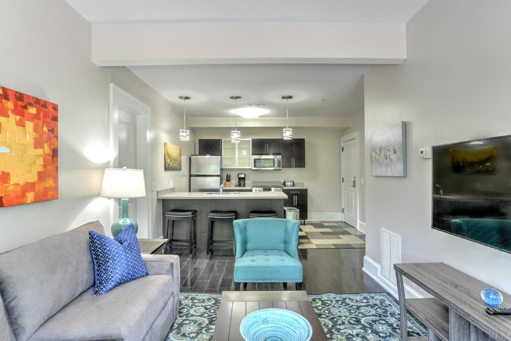 a living room with a couch and a kitchen at Historic King James Unit 4 in Asheville