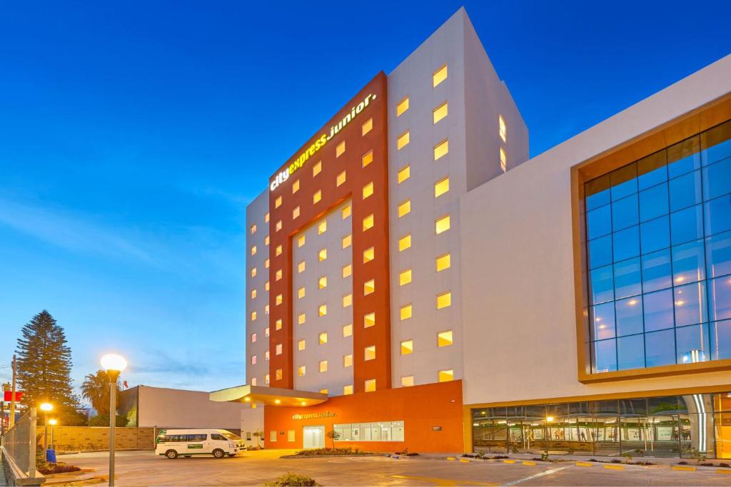 a large building with a parking lot in front of it at City Express Junior by Marriott Leon Centro de Convenciones in León