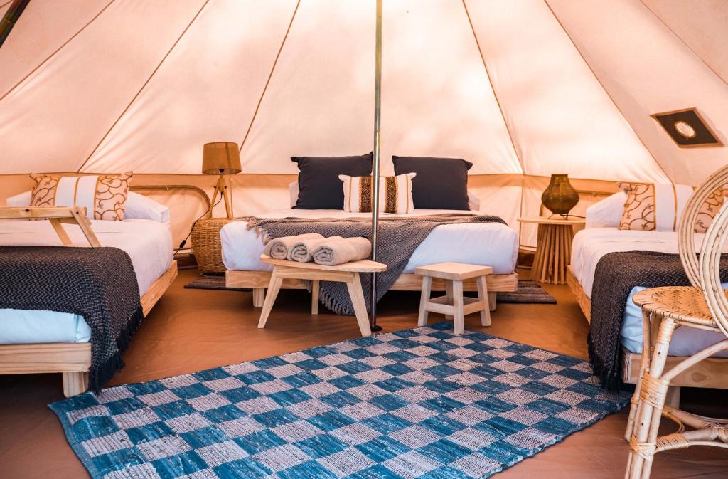 1 dormitorio con 2 camas en una yurta en Terranova Glamping en Luján