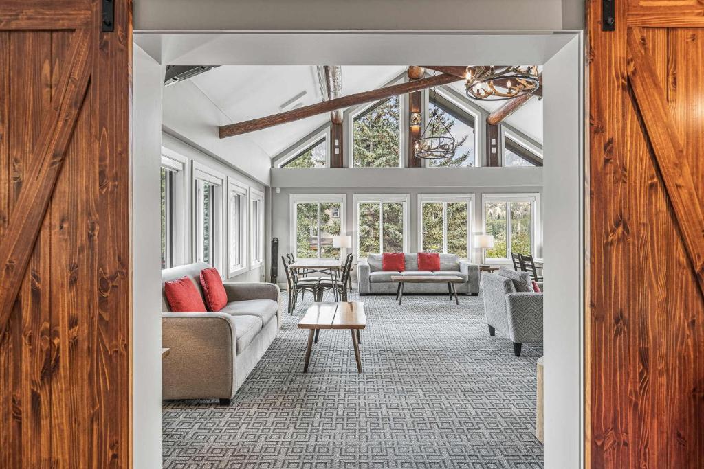 a living room with couches and a table at Basecamp Lodge Canmore in Canmore