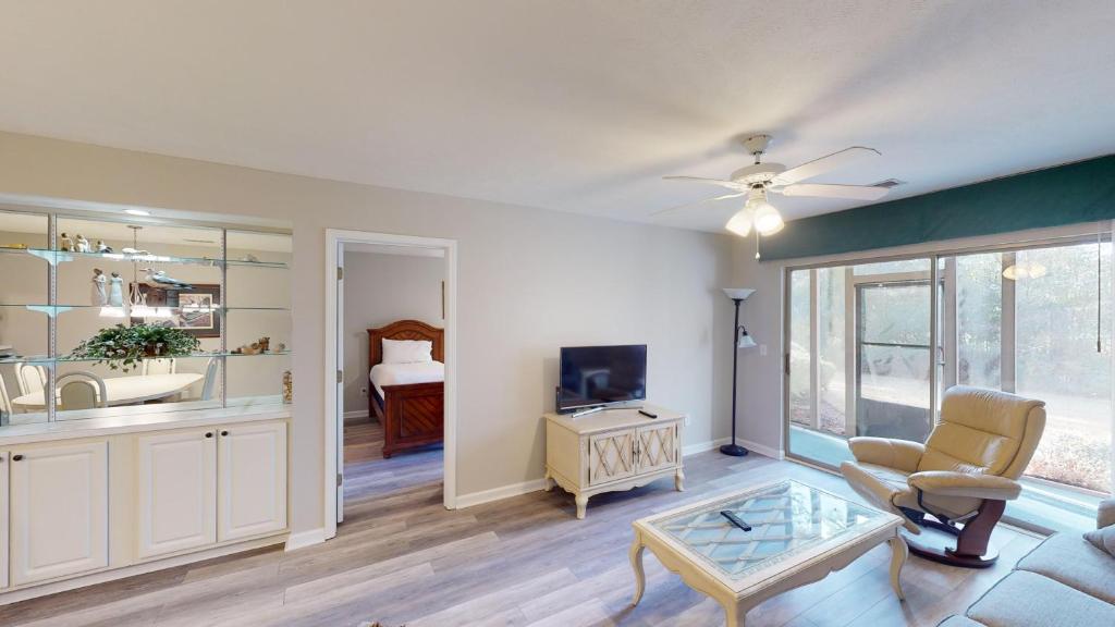 a living room with a couch and a tv at Scenic Serenity 2BR Villa with Private Balconies in Pawleys Island