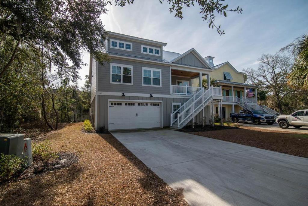 a large house with a garage and a driveway at Island Escape Relax and Unwind in Pawleys Island in Pawleys Island