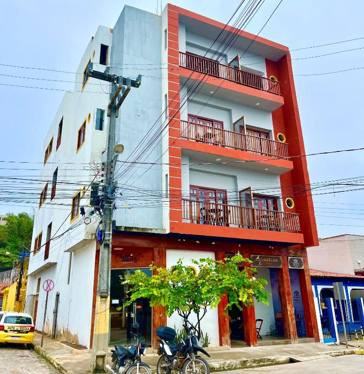 a building with two motorcycles parked in front of it at Pousada Sete Mares in Maragogi
