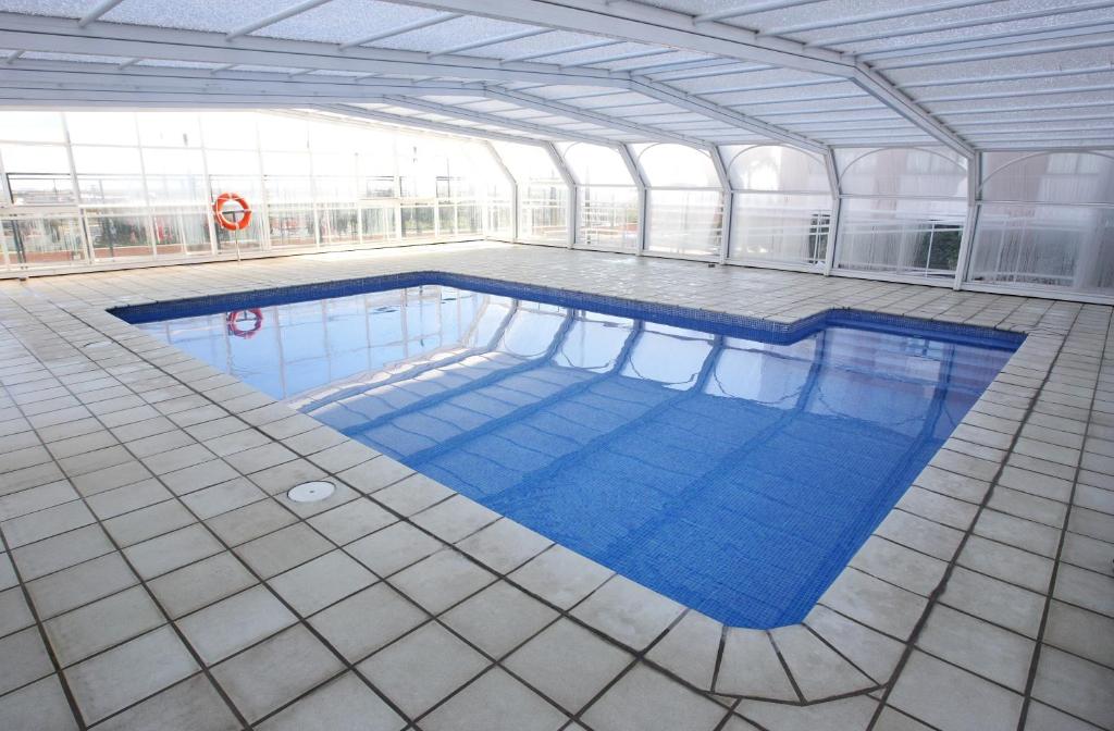 a large swimming pool in a building at Hotel Albufera in Alfafar