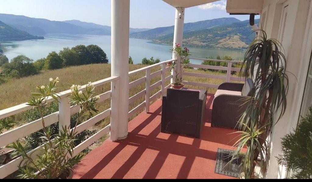 a porch with a view of the water at Marković Apartments (vidikovac) in Donji Milanovac