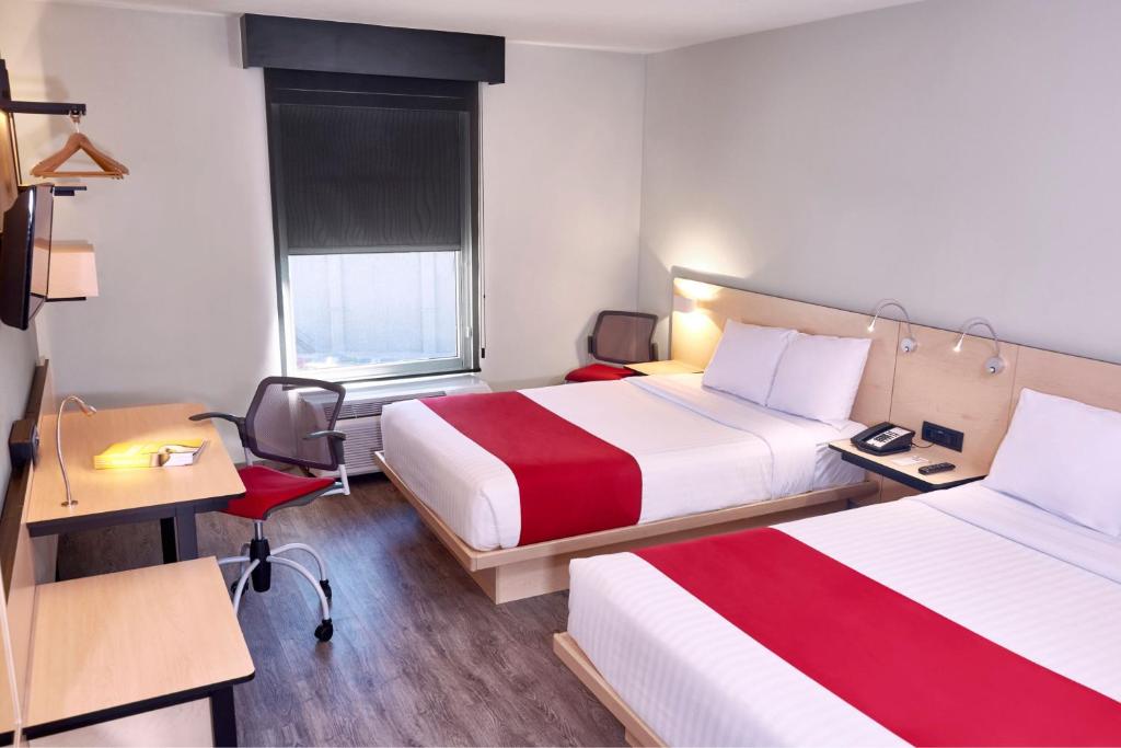 Postel nebo postele na pokoji v ubytování City Express by Marriott Leon