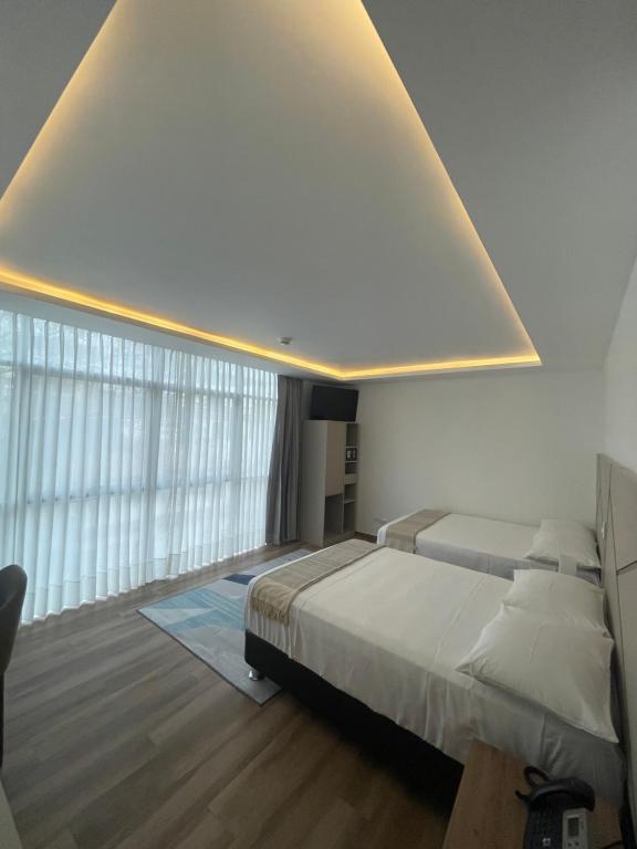 Postel nebo postele na pokoji v ubytování Grau Business Hotel