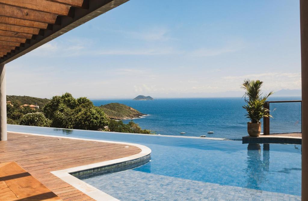 a swimming pool with a view of the ocean at Casa Mirador Boutique Hotel in Búzios