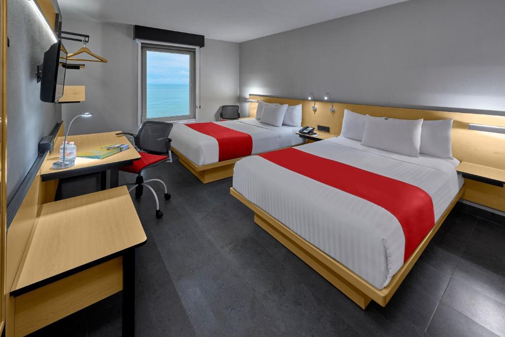 Postel nebo postele na pokoji v ubytování City Express by Marriott Veracruz