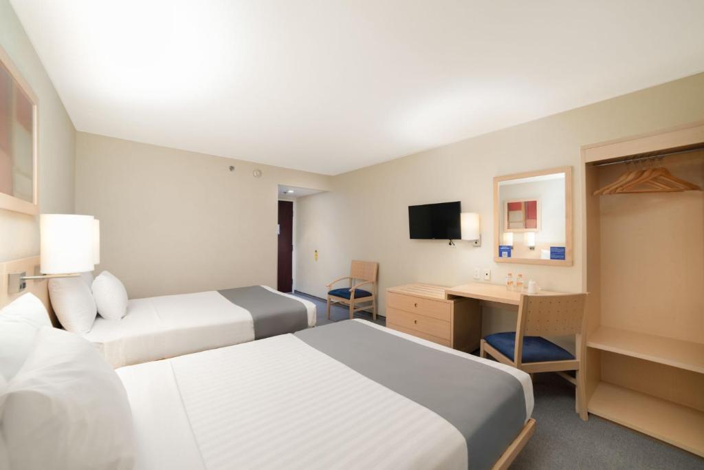 Postel nebo postele na pokoji v ubytování City Express by Marriott Tula