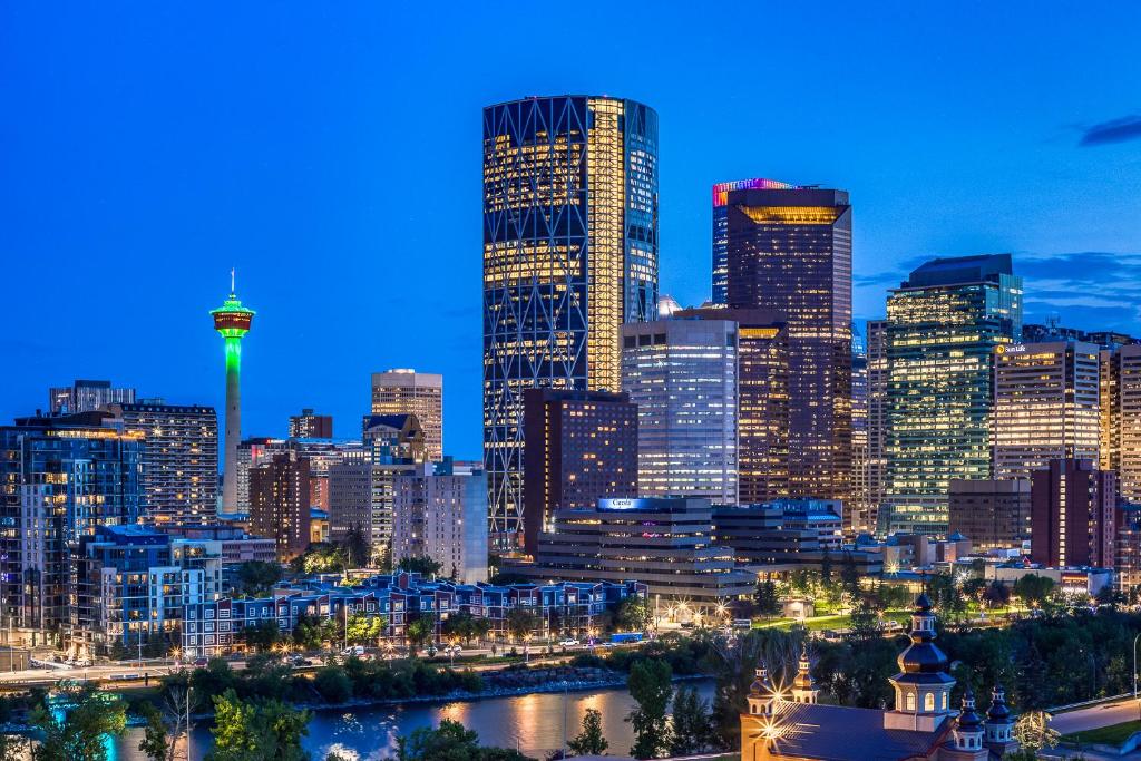 a view of a city skyline at night at Steps from downtown Calgary a Suite with a VIEW in Calgary