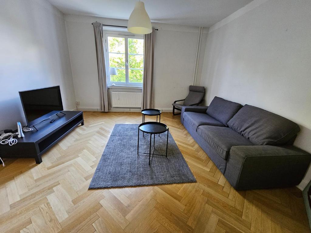 a living room with a couch and a table at Home Inn RSG19 in Stockholm