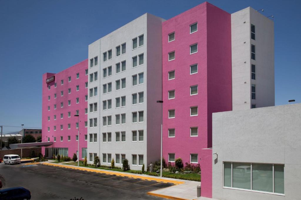 a row of colorful buildings on a street at City Express by Marriott Suites Toluca in Toluca