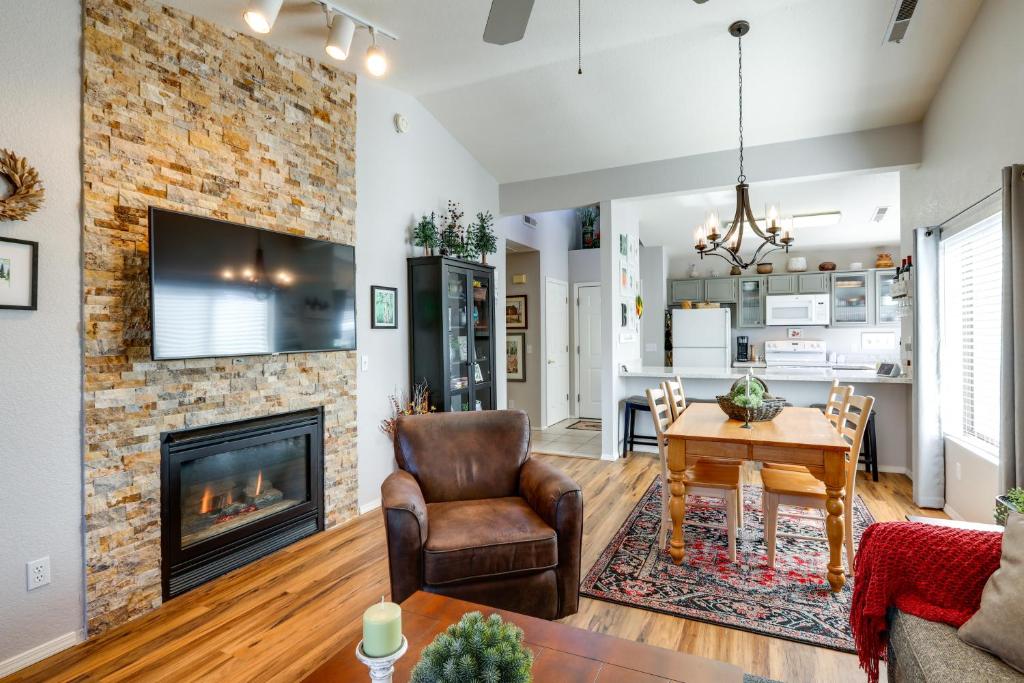 a living room with a fireplace and a table and chairs at Cozy Flagstaff Retreat with Fireplace and Gas Grill! in Flagstaff