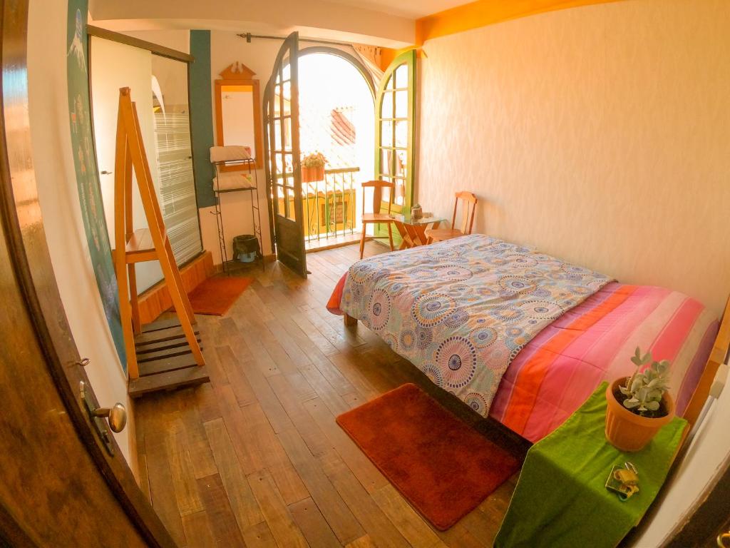 a bedroom with a bed in a room with a staircase at Anata Hostal in La Paz