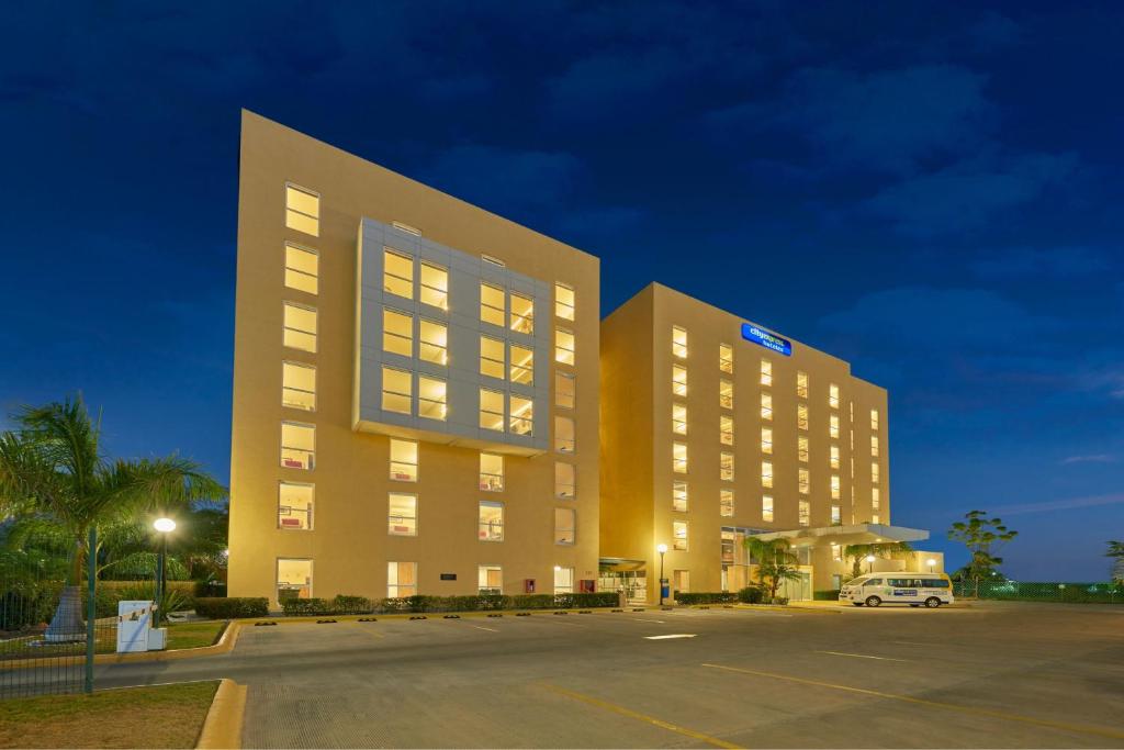 a large building with a parking lot in front of it at City Express by Marriott Salamanca in Salamanca