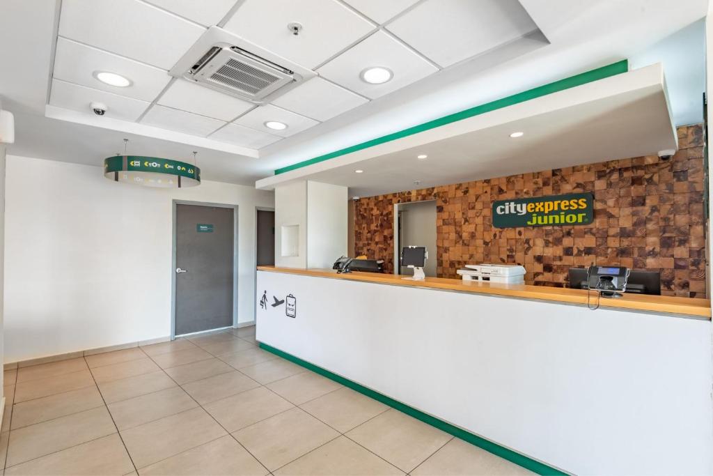 a lobby of a dental office with a reception counter at City Express Junior by Marriott Villahermosa in Villahermosa