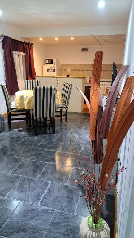a kitchen and living room with a table and chairs at MG ESQUEL in Esquel