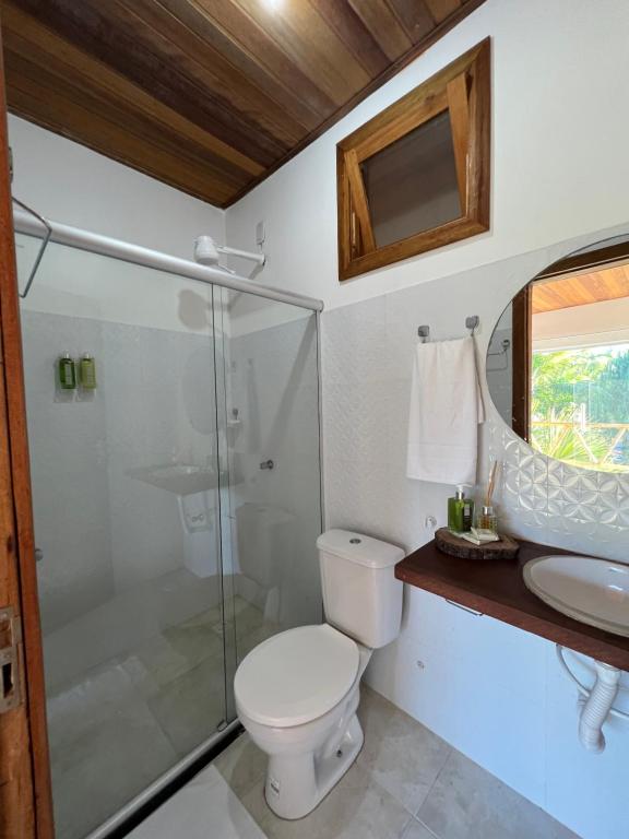 a bathroom with a toilet and a shower and a sink at Pousada Oceano Atlântico in Marau