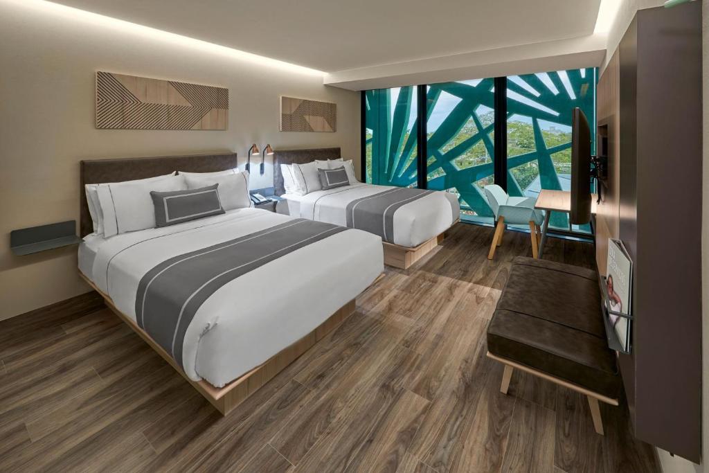 Postel nebo postele na pokoji v ubytování City Express Plus by Marriott Merida