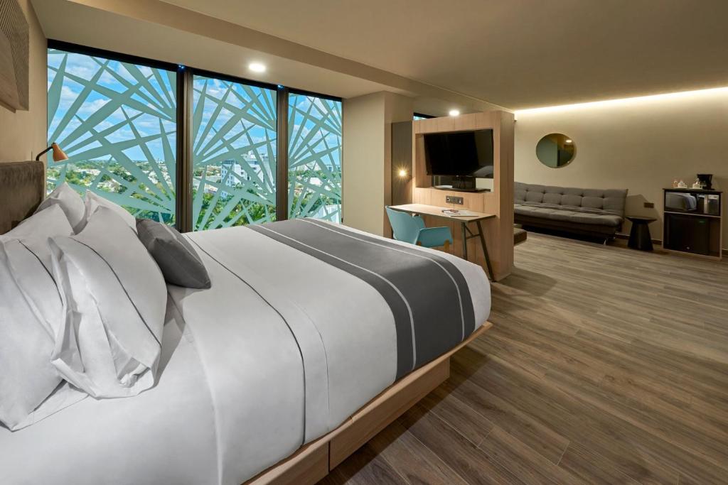 Postel nebo postele na pokoji v ubytování City Express Plus by Marriott Merida