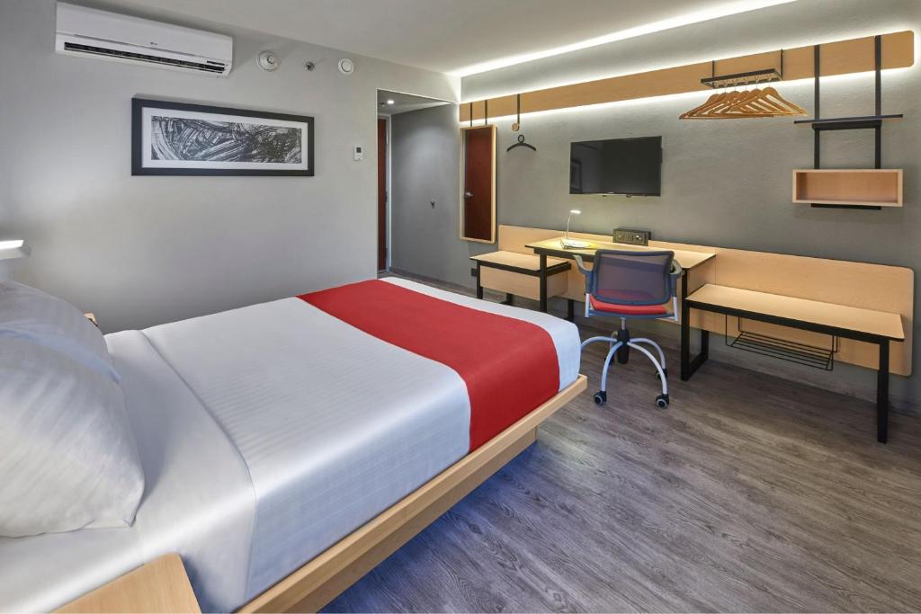 Postel nebo postele na pokoji v ubytování City Express by Marriott Queretaro