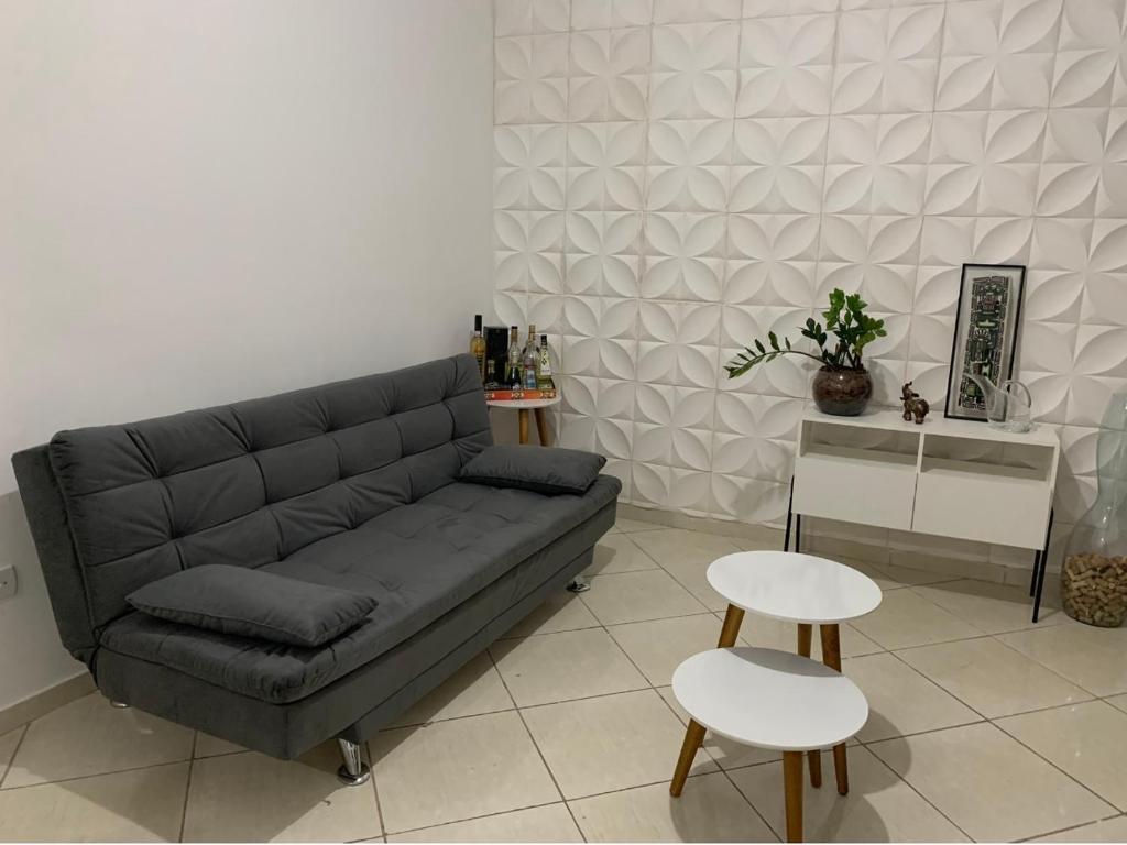 una sala de estar con un sofá, una mesa y sillas en Apartamento confortável com espaço exclusivo, en Cachoeira Paulista