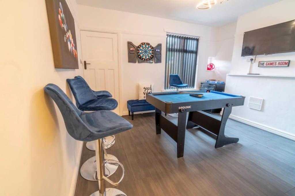 a room with a blue ping pong table and chairs at Entire home in Nottingham in Nottingham