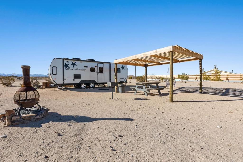 a campground with a trailer and a picnic table and a tent at JT Village Campground - Star Stream in Joshua Tree