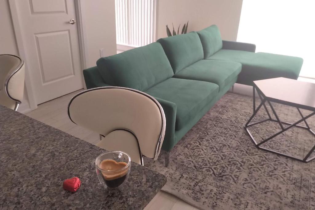 a living room with a green couch and a table at GGP Boutique Townhome in Vaughan