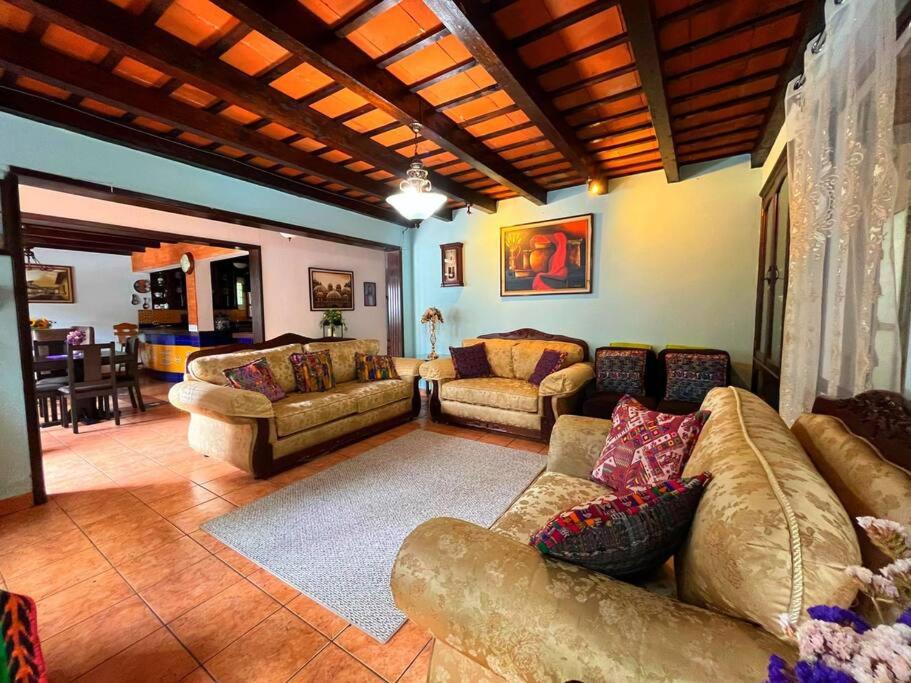 a living room with couches and a couch and a table at CasaDe Leon-Hotel Boutique in Antigua Guatemala