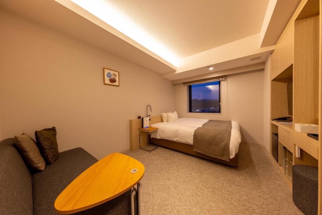 Postel nebo postele na pokoji v ubytování Hotel Granbinario Tsuruga