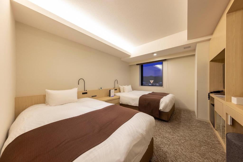 Postel nebo postele na pokoji v ubytování Hotel Granbinario Tsuruga