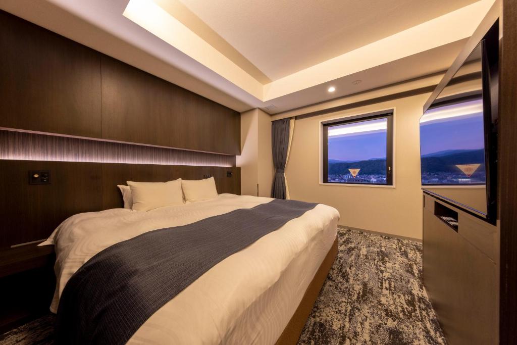 Postel nebo postele na pokoji v ubytování Hotel Granbinario Tsuruga
