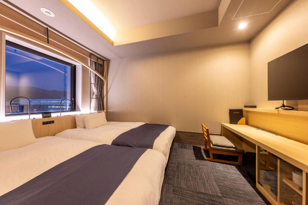 Postel nebo postele na pokoji v ubytování Hotel Granbinario Tsuruga