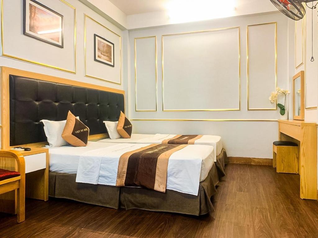 Postel nebo postele na pokoji v ubytování Hotel Việt Mỹ