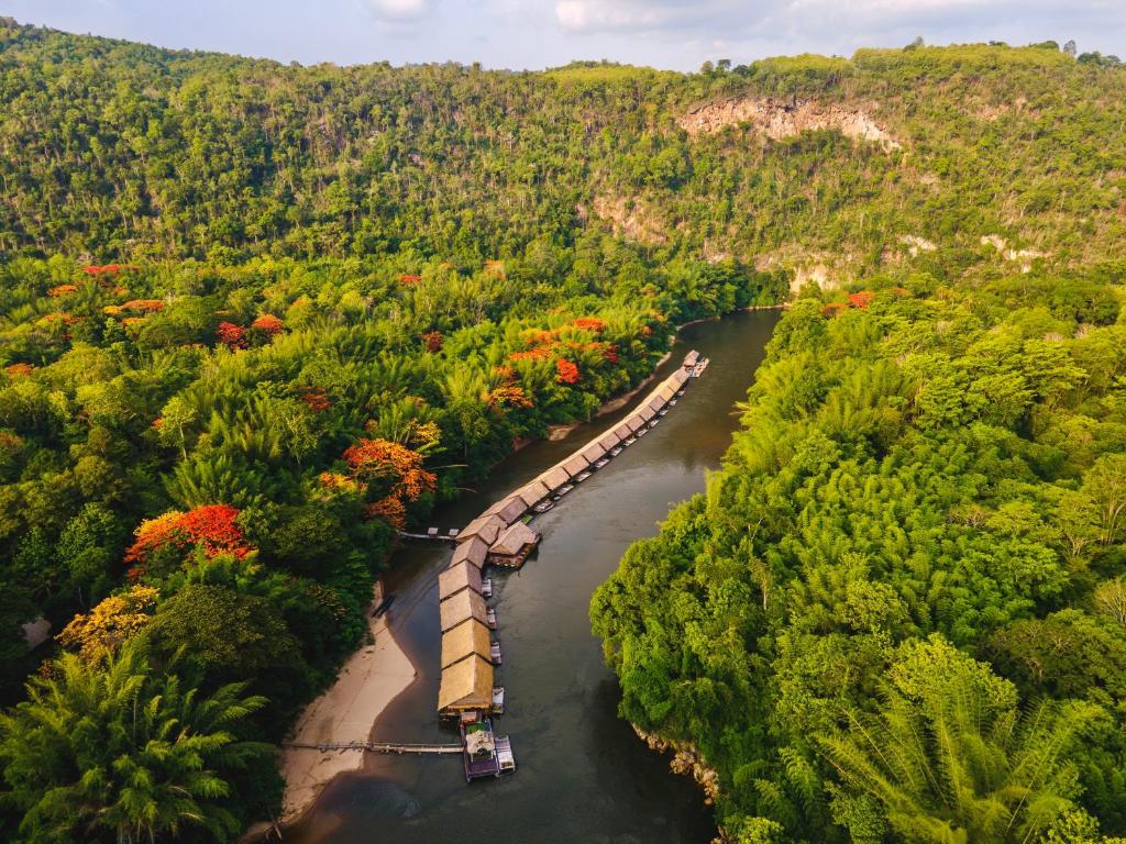 een lange trein op een rivier in een bos bij River Kwai Jungle Rafts - SHA Extra Plus in Sai Yok