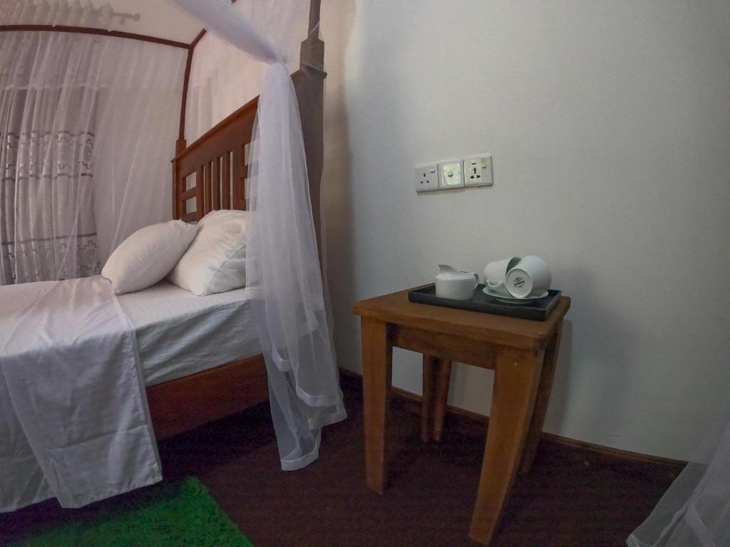 Postel nebo postele na pokoji v ubytování Wilpattu Mookalan Resort