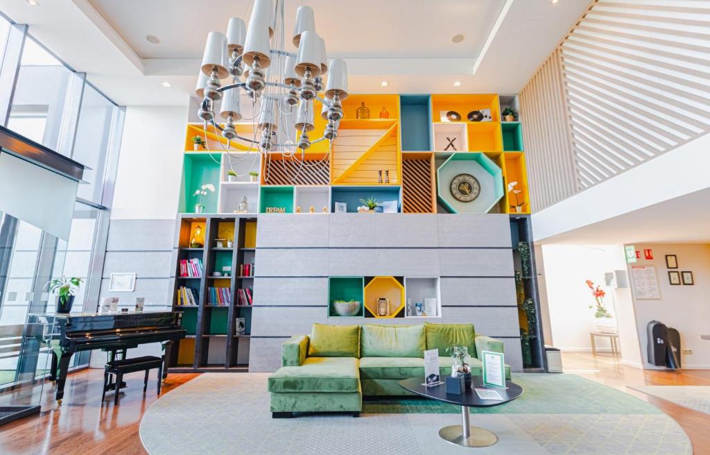 a living room with a couch and a table at Holiday Inn Mulhouse, an IHG Hotel in Mulhouse