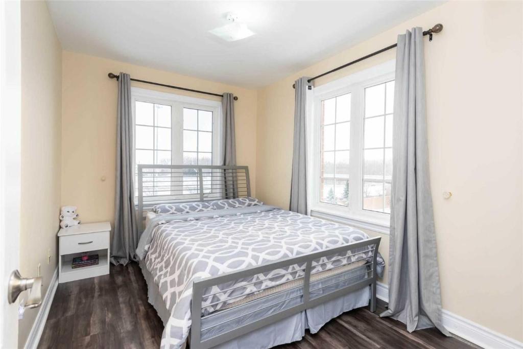 a bedroom with a bed and a large window at Jazzy Home Stay in Mississauga