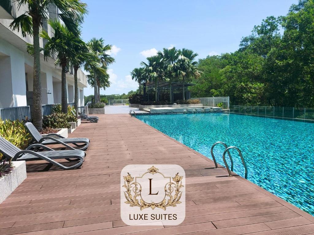 a swimming pool with a sign that reads live suites at Luxe Suites at Skyloft in Johor Bahru