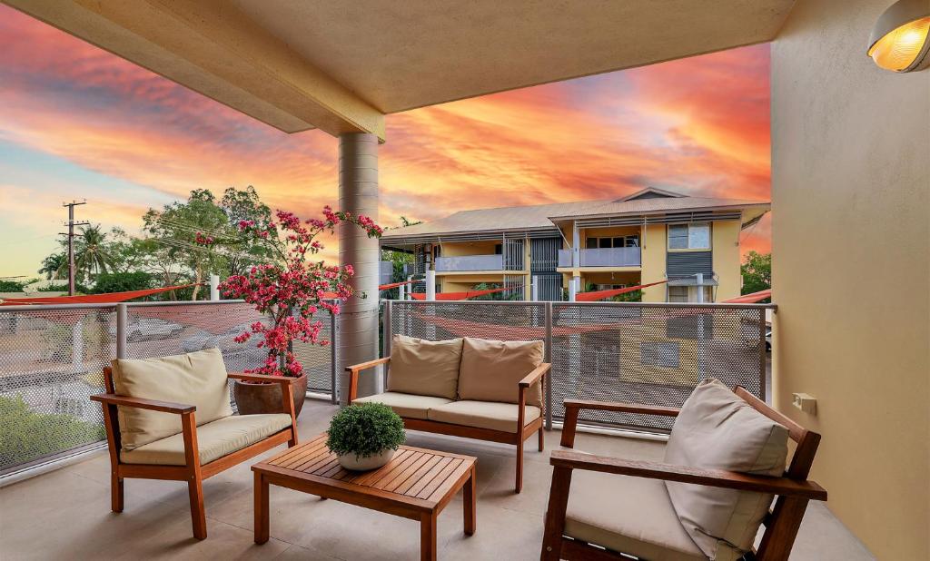 a balcony with chairs and a painting of a sunset at Parap Markets Condo 2BR 2BA (ens) in Paraparap