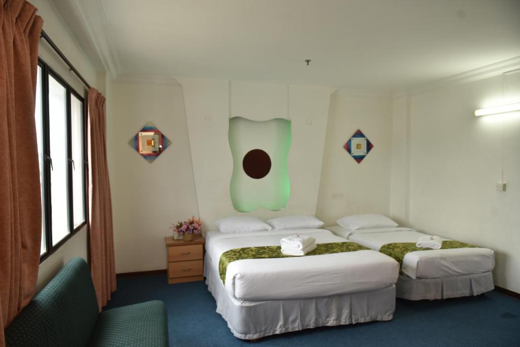 Postel nebo postele na pokoji v ubytování Fair Park Hotel