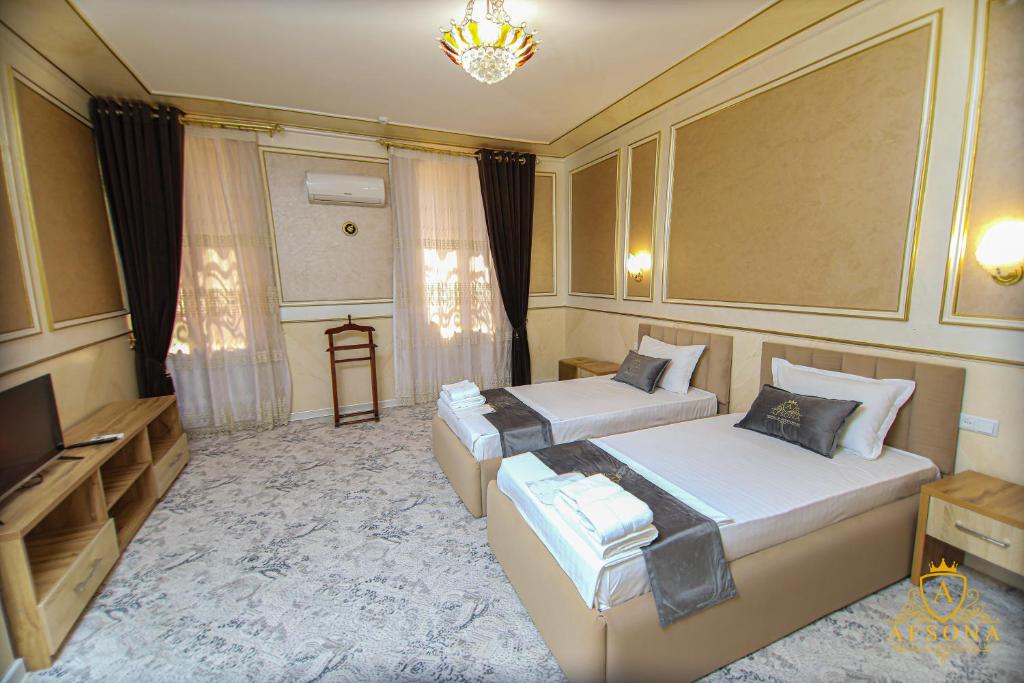 Postel nebo postele na pokoji v ubytování Afsona Hotel