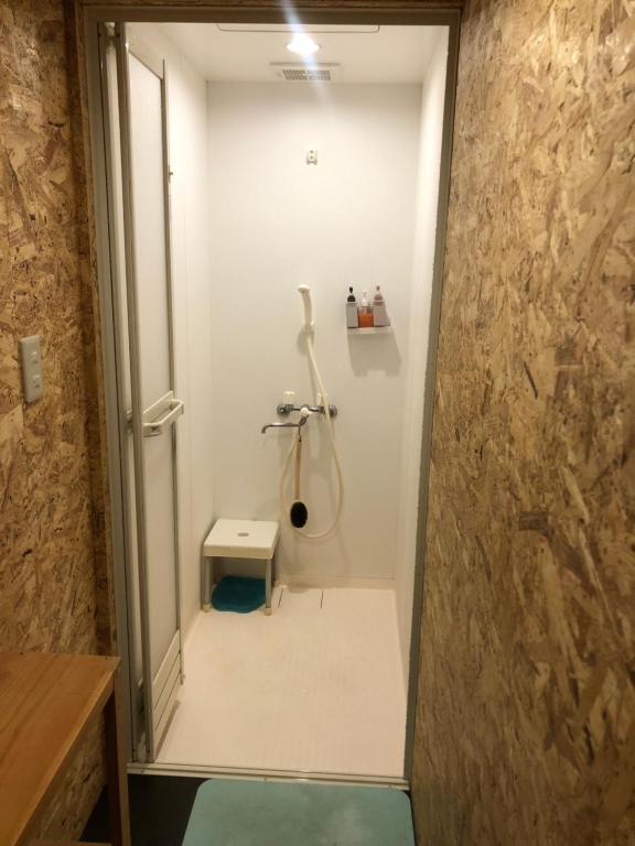 a bathroom with a shower and a toilet in it at GUEST HOUSE NAGORIYA in Hikone