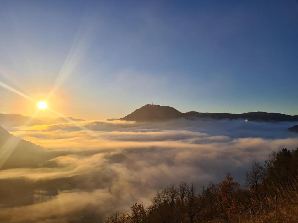 a view of the sun rising over a sea of clouds at Camping à la ferme in Saint-Germain-de-Calberte